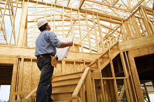 Man at construction Site with Plans