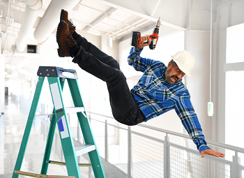 Man in a hard hat and holding a drill falling off of a ladder