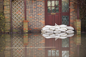 sandbags against a door on a flooded street