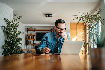 Man Working From Kitchen Table